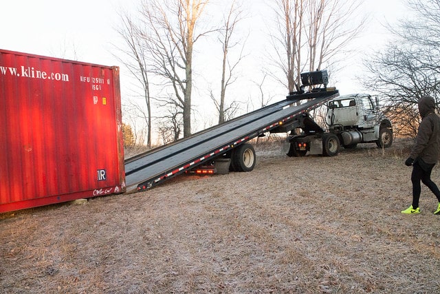 Delivery of our first shipping container to build our tiny house in Upstate New York!  This post shows pricing and how to get it delivered.