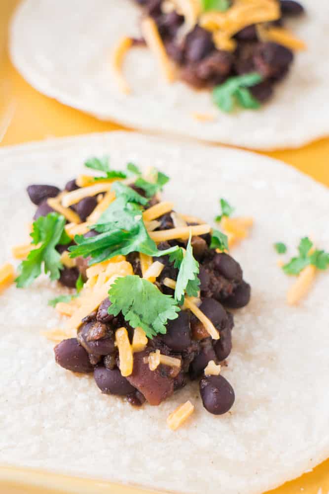 Slow Cooker Black Beans are slow cooked with spices for 4 hours. They make delicious tacos!