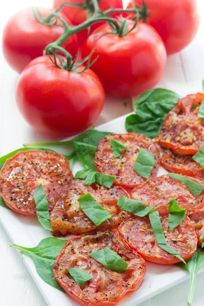 Fresh tomatoes are roasted with olive oil for 25 minutes to make this Roasted Tomato Salad. It's a perfect way to enjoy your fresh Summer tomatoes!