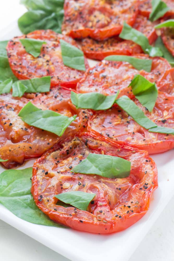 HEALTHY, SIMPLE Roasted Tomato Salad recipe for fresh Summer tomatoes!  Fresh tomatoes are roasted with olive oil for 25 minutes to create a delicious salad!  Serve as a EASY salad, side dish or appetizer! You can use any type of tomatoes - including roma, cherry and heirloom! 