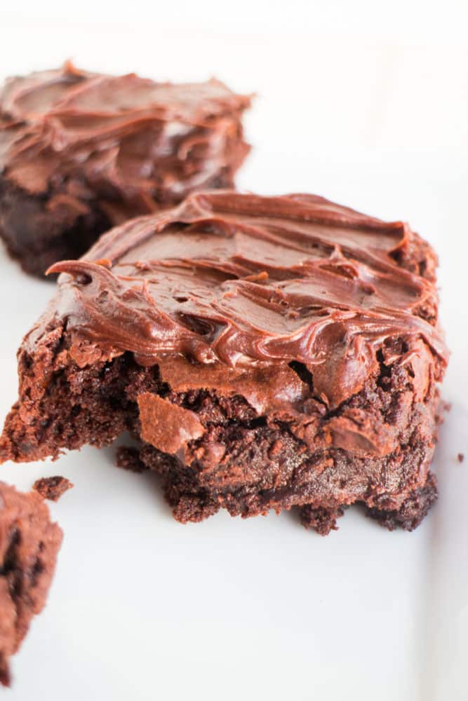FUDGY Chocolate Brownies made with SELTZER water! Easy Homemade Double Chocolate Brownies recipe that uses seltzer water to make the brownies extra fluffy and moist! These gooey brownies are made from scratch and have a amazing chocolate frosting on top! My husband considers these the BEST brownies ever!