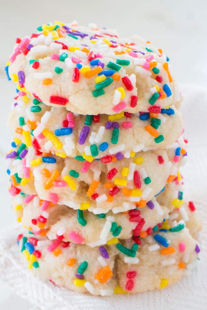 Sprinkled Butter Cookies are delicious! Roll them around in colored sprinkles to make them more festive. This recipe uses evaporated milk to make the cookies extra soft! Recipe makes 2 dozen cookies.