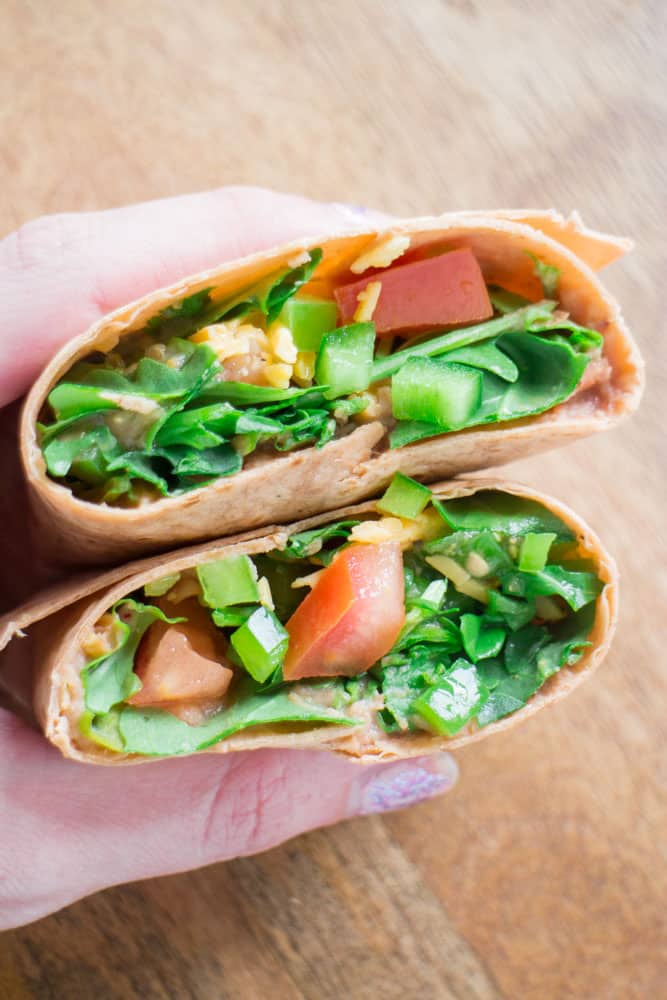 Arugula Refried Bean Burrito is a healthy Summer meal made with canned refried beans and fresh arugula. Dinner is made in 5 minutes!