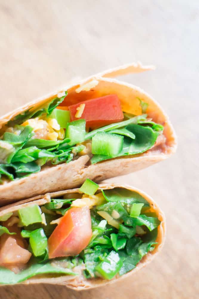 Arugula Refried Bean Burrito is a healthy Summer meal made with canned refried beans and fresh arugula. Dinner is made in 5 minutes!