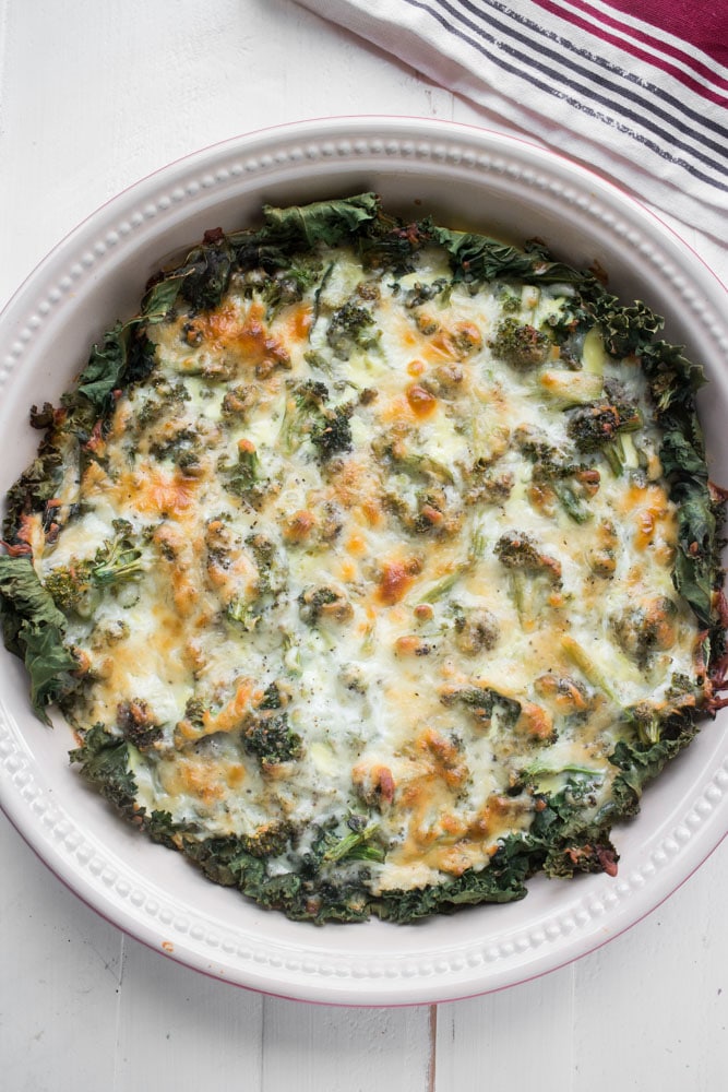 This Cheesy Broccoli Quiche is a easy to make dinner recipe! Instead of the traditional pie crust, we're using kale to line the bottom of the casserole dish. It's the perfect balance of cheesy and vegetables!