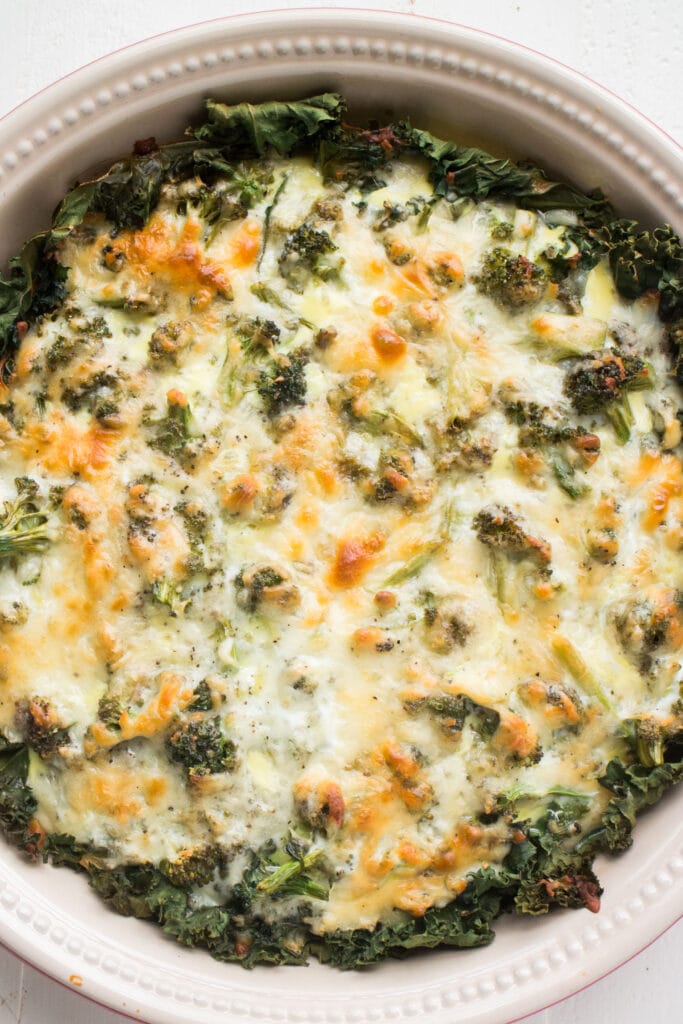 cheesy broccoli quiche in circulra pie dish.