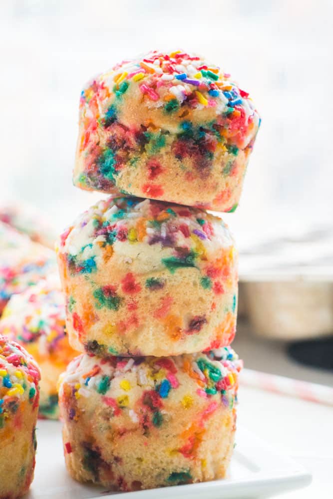 Fluffy, SPRINKLE BIRTHDAY CAKE Muffins that taste just like birthday cake! This is a easy rainbow muffins recipe that is pretty and perfect for happy birthday parties and birthday breakfast.  Kids LOVE these FUN birthday muffins!  