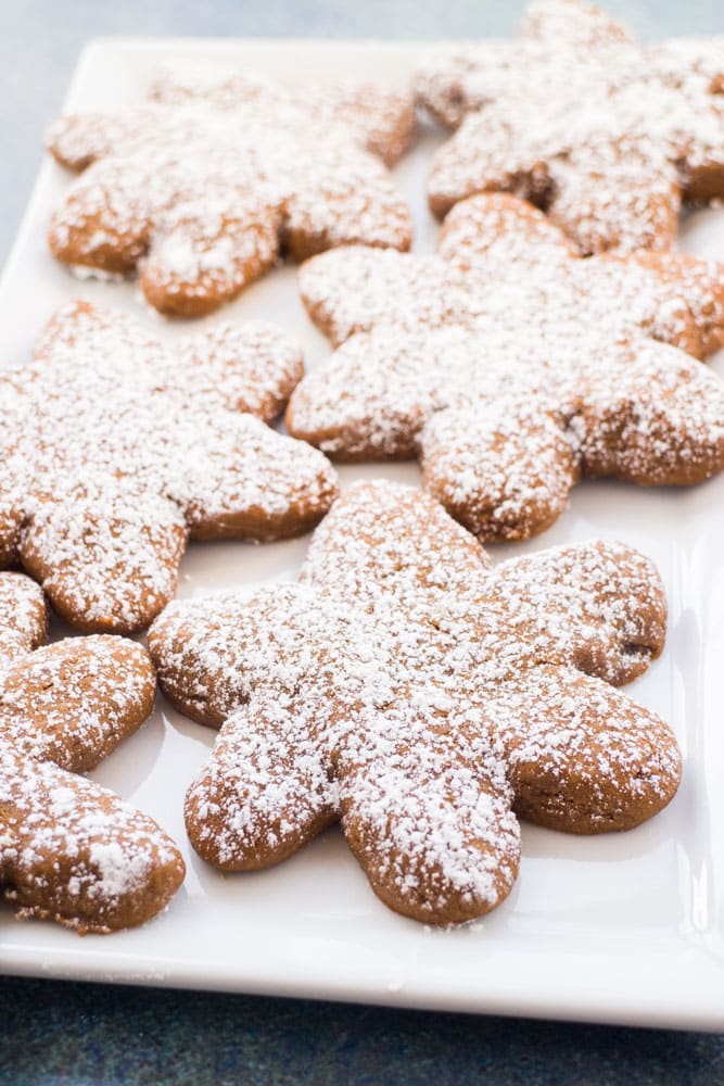 Soft Gingerbread Cookies with a sprinkle of powdered sugar over the top are the perfect festive treat! These cookies are so soft and chewy and this easy recipe doesn’t require you to chill the dough, so they’re quick and simple to make! Don’t let the holiday season get away without baking up a batch!