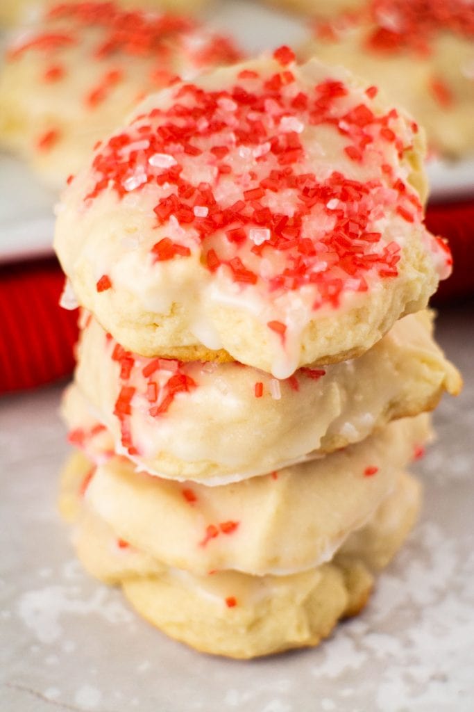 stack of christmas sugar cookies with red and white sprinkles