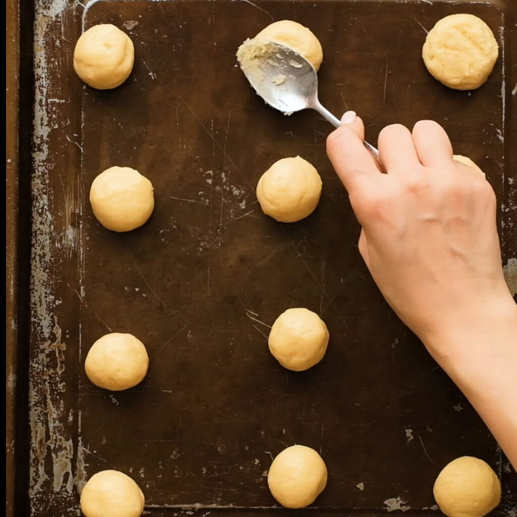 cookie balls on baking sheet.
