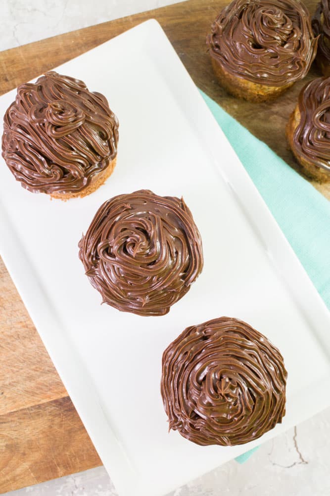 Delicious Banana Bread Muffins that are topped with Chocolate Frosting! These are made with 3 whole bananas and taste just like baked banana bread!