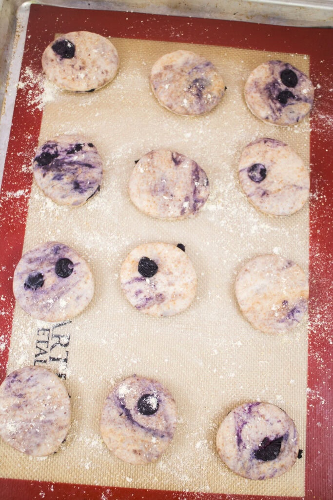 english muffins cut out in circles on baking sheet.