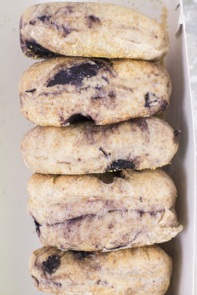 closeup image of blueberry english muffins in container.