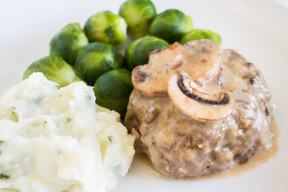 Easy Salisbury Steak recipe that is baked in the oven. This simple dinner uses a homemade gravy ground beef and bread crumbs. Includes how to freeze Salisbury steak instructions if you want to make this ahead of time for a freezer meal. Includes how to freeze Salisbury steak instructions if you want to make this ahead of time for a freezer meal. 