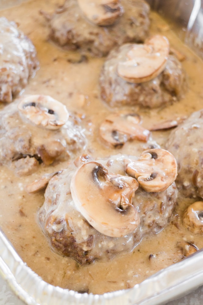 Easy Salisbury Steak recipe that is baked in the oven. This simple dinner uses a homemade gravy ground beef and bread crumbs. Includes how to freeze Salisbury steak instructions if you want to make this ahead of time for a freezer meal. Includes how to freeze Salisbury steak instructions if you want to make this ahead of time for a freezer meal. #salisburysteak #groundbeef #dinner #comfortfood #freezermeal #easyrecipe