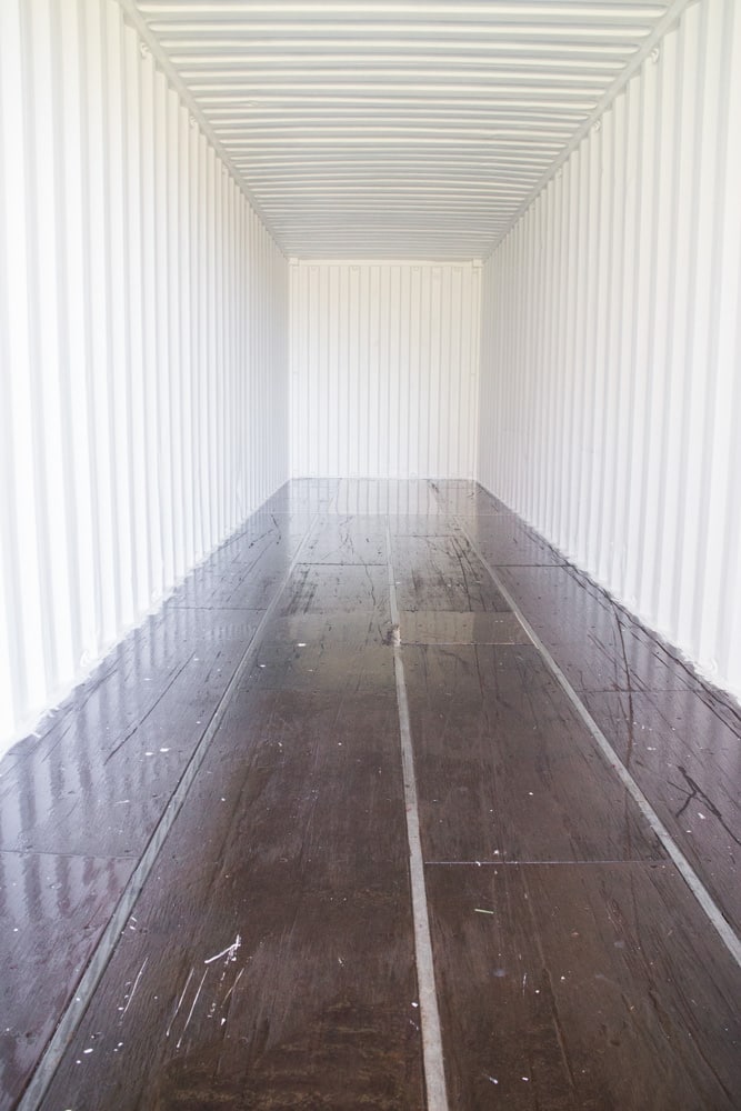 How to remodel a shipping container's floor to make it move in ready. Find out how to easily refinish the floors on a budget to turn it into your modern dream home! Great design inspiration and cost info for your shipping container house! 