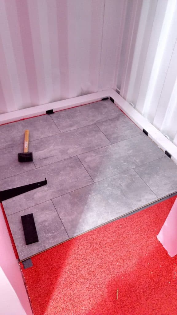 How to remodel a shipping container's floor to make it move in ready. Find out how to easily refinish the floors on a budget to turn it into your modern dream home! Great design inspiration and cost info for your shipping container house! 