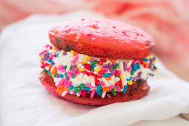 It's time to celebrate with these classic Vanilla Whoopie Pies! This easy recipe makes delicious vanilla whoopie cake pies with marshmallow creme filling (just like homemade Amish Whoopie Pies!). These pretty treats are perfect for a birthday party or baby shower celebration (Its a girl!) with the help of pink food coloring and rainbow sprinkles. 