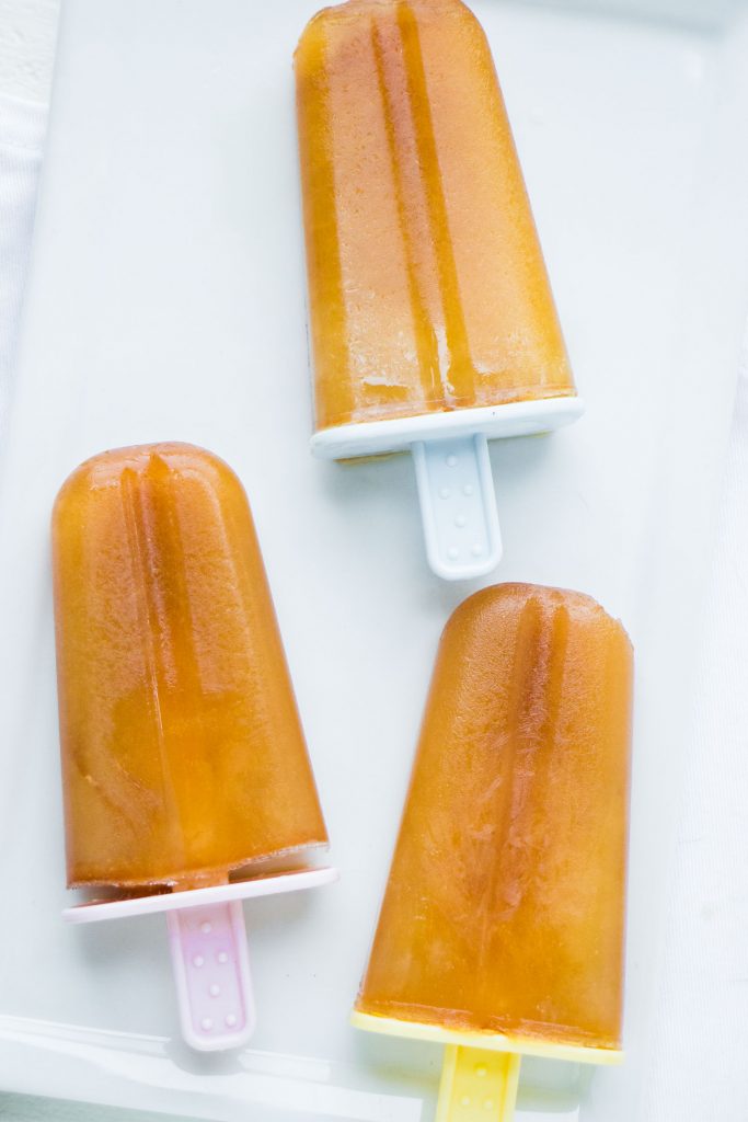 3 earl grey popsicles that are frozen on white background