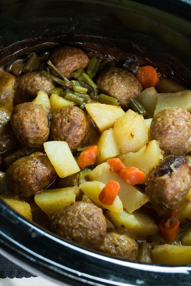 SLOW COOKER Meatball Potato Casserole with a creamy beef gravy is delicious!  This easy to make crockpot recipe is perfect for busy weeknights! This Italian Meatballs dish uses cream of mushroom soup and is filled with vegetables including potatoes, carrots, celery and onion!  My husband officially declares this one of his favorite meals!  