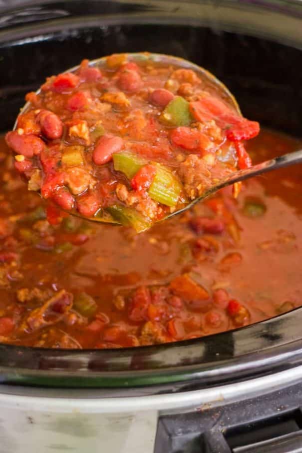 PAMELA'S PORKY Slow Cooker CHILI is made with BACON and SAUSAGE! This pork chili is easy to make in the crockpot with diced tomatoes and beans! It's one of my families favorite comfort food dinners!   Ready in 6 hours on LOW. Serve with shredded cheese and a big piece of crusty bread!
