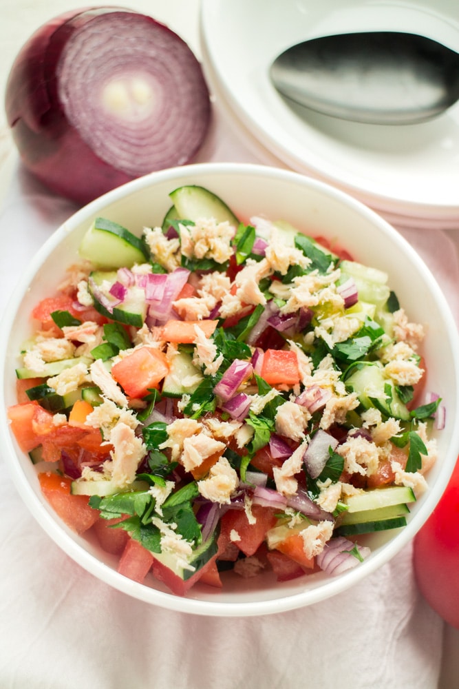 HEALTHY Tuna Cucumber Tomato Salad with olive oil dressing! This super easy salad recipe is only 140 calories a serving! I love using fresh tomatoes, cucumber and onions from the garden! It's completely dairy free too! 