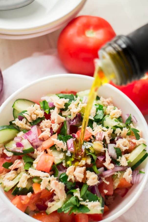 HEALTHY Tuna Cucumber Tomato Salad with olive oil dressing! This super easy salad recipe is healthy and only 140 calories a serving! I love using fresh tomatoes, cucumber and onions from the garden! It's completely dairy free too! 