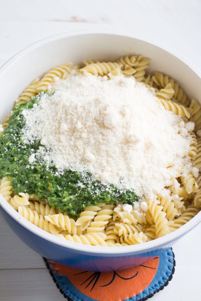 pasta with pesto and parsmean cheese added on top.