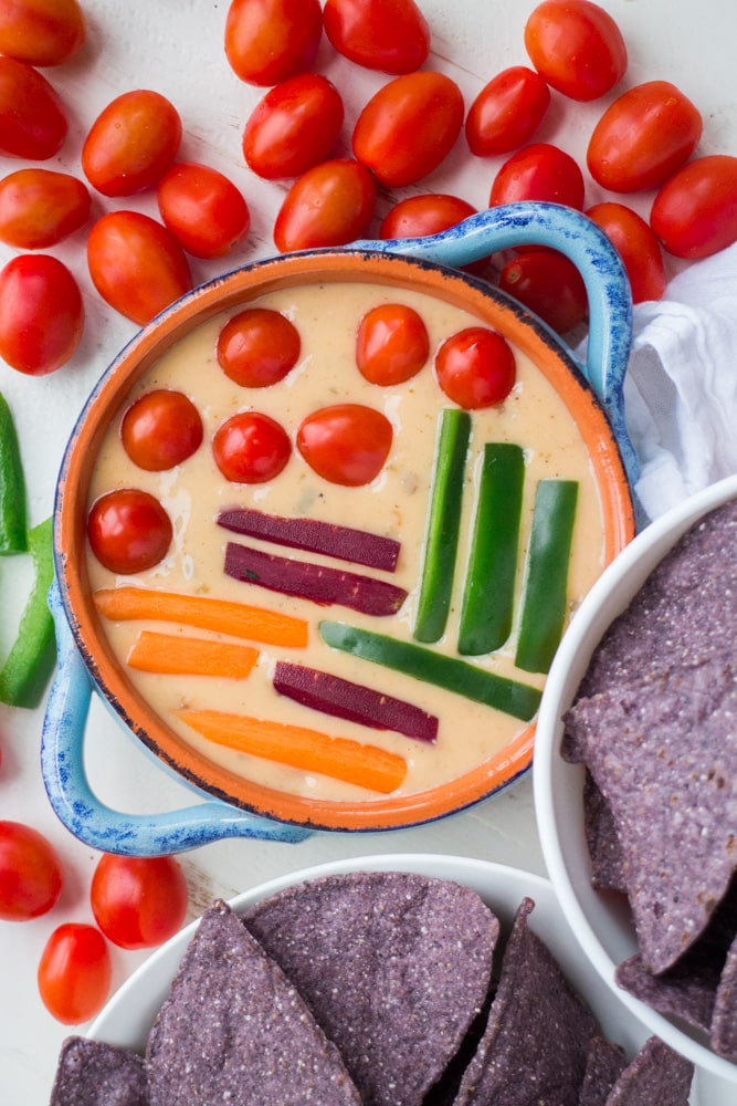 This Mexican cheese dip is a creamy and zesty blend of Monterey Jack cheese and seasonings, all melted to gooey perfection. This easy homemade cheese dip has just a handful of ingredients and can be whipped up super quick. Cover the top with chopped up vegetables for the perfect addition to any party menu!