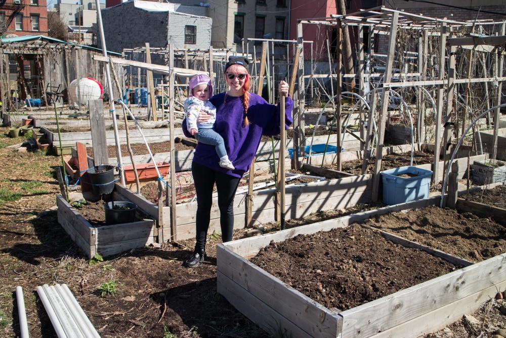 pink haired mom with baby in garden