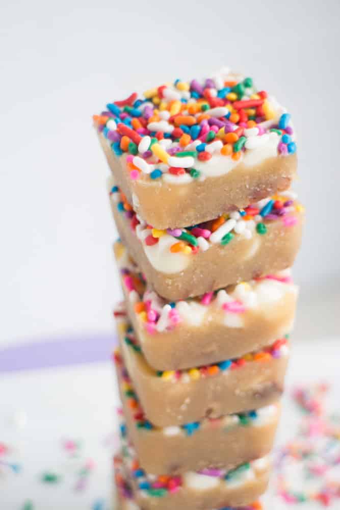 EASY White Chocolate Toffee Recipe with rainbow sprinkles! You're going to love this sticky homemade candy that has a base of crushed up pecans. Cut into squares or break up into bark! 