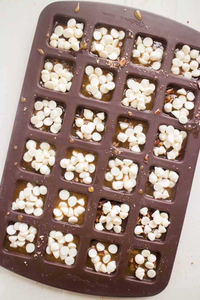 EASY White Chocolate Toffee Recipe with rainbow sprinkles! You're going to love this sticky homemade candy that has a base of crushed up pecans. Cut into squares or break up into bark! 