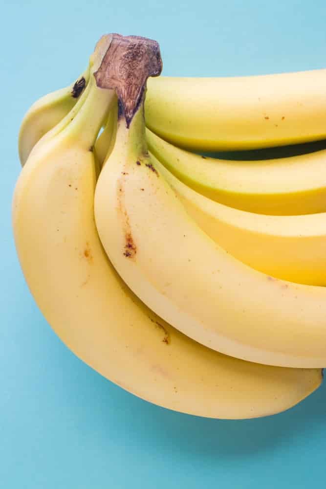 How to Store Bananas!  These easy tips will prevent your bananas from turning brown!  Tricks includes storing with other fruit, plastic wrap, banana trees and how to freeze bananas!  Learn the best ways to store bananas and keep them green for longer!