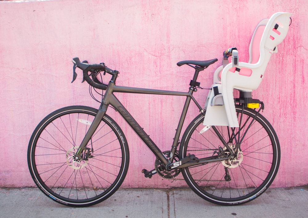 Full guide on bike riding with a baby! We started riding in NYC with our baby at 10 months old. Learn about the best baby bike seat, baby helmet and how to stay safe when cycling. 