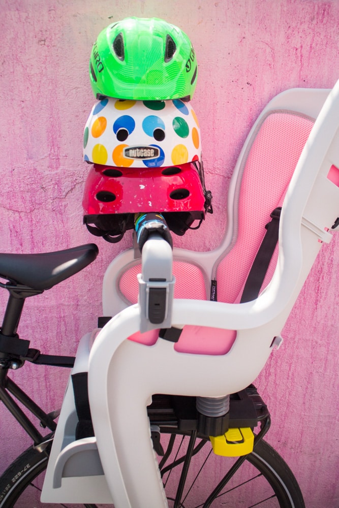 Full guide on bike riding with a baby! We started riding in NYC with our baby at 10 months old. Learn about the best baby bike seat, baby helmet and how to stay safe when cycling. 
