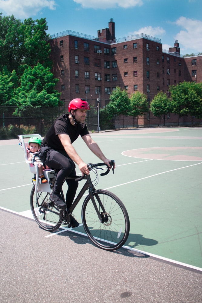 Full guide on bike riding with a baby! We started riding in NYC with our baby at 10 months old. Learn about the best baby bike seat, baby helmet and how to stay safe when cycling. 