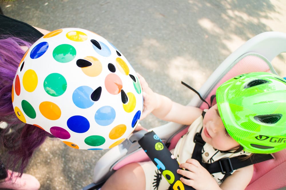 Full guide on bike riding with a baby! We started riding in NYC with our baby at 10 months old. Learn about the best baby bike seat, baby helmet and how to stay safe when cycling. 