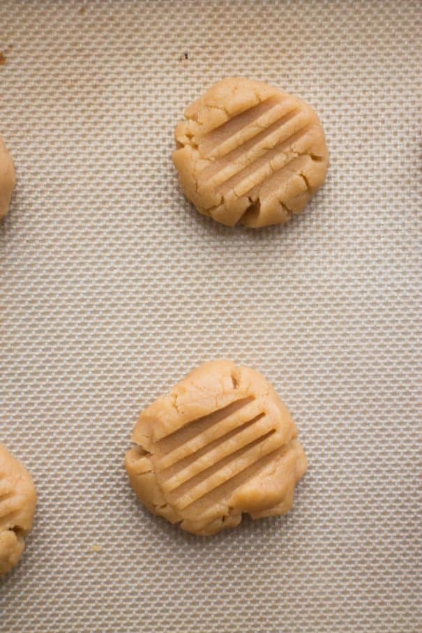 peanut butter cookies on silicone baking mat on cookie sheet