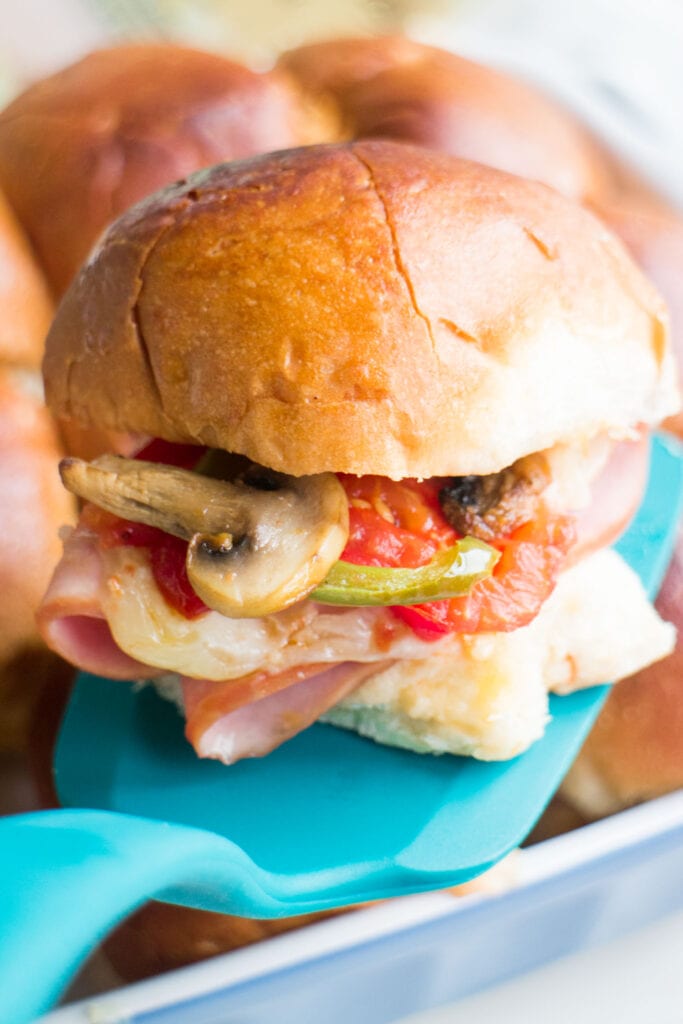 closeup of italian slider sandwich with meat and vegetables on it.