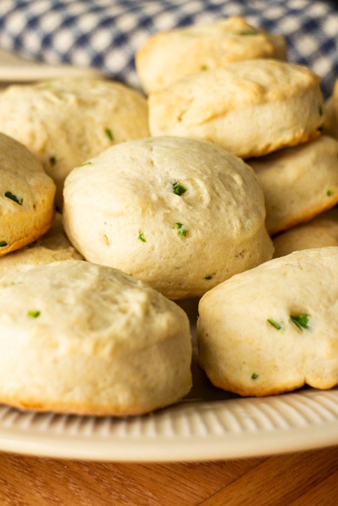 buttermilk jalapeno biscuits stacked on top of each other on plate.