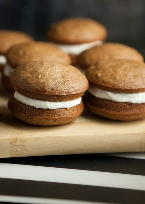These incredible pumpkin whoopie pies are made with two soft and fluffy pumpkin cake-like cookies and a layer of marshmallow filling sandwiched in between. It’s a fun and perfect little treat you can eat right out of your hands.