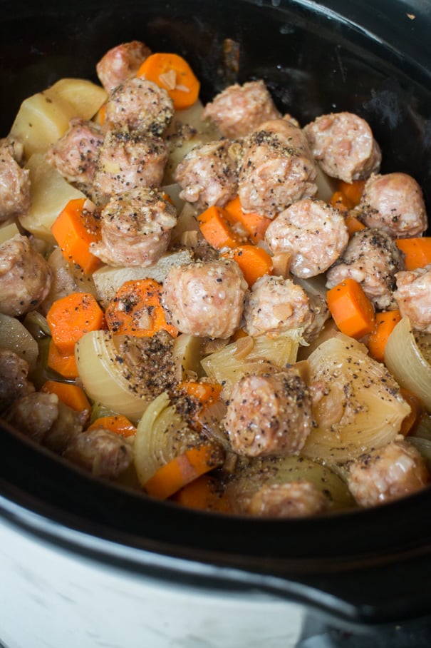 Slow Cooker Sausage and Cabbage is a easy crock pot recipe ready in 6 hours! Add Sweet Italian Sausage links and vegetables (potatoes, cabbage, carrots and onion!) into your slow cooker for a delicious comfort meal!