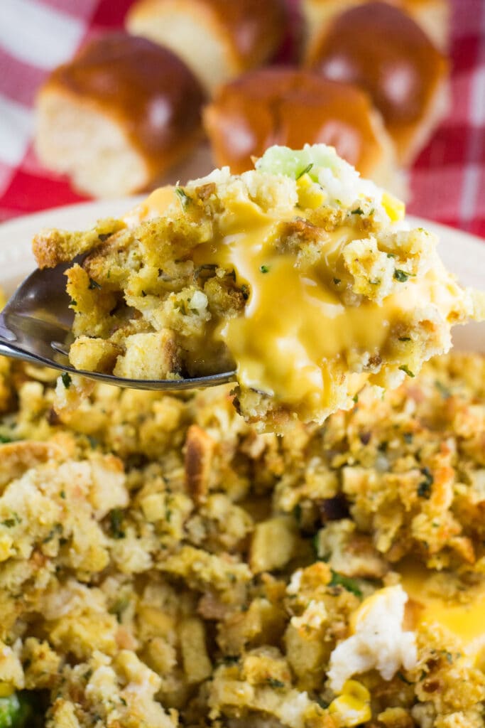 spoon filled with cheesy stuffing.