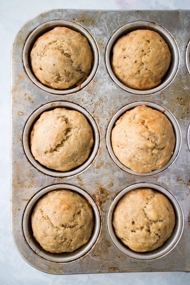 EASY Moist Banana Muffins Recipe made with yogurt! These healthy muffins only need 2 tablespoons of butter and 1/4 cup brown sugar!   My entire family thinks these are the best muffins for breakfast and dessert!