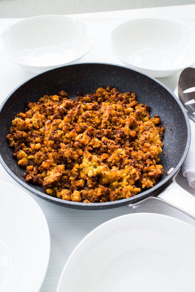skillet filled with stuffing on table.