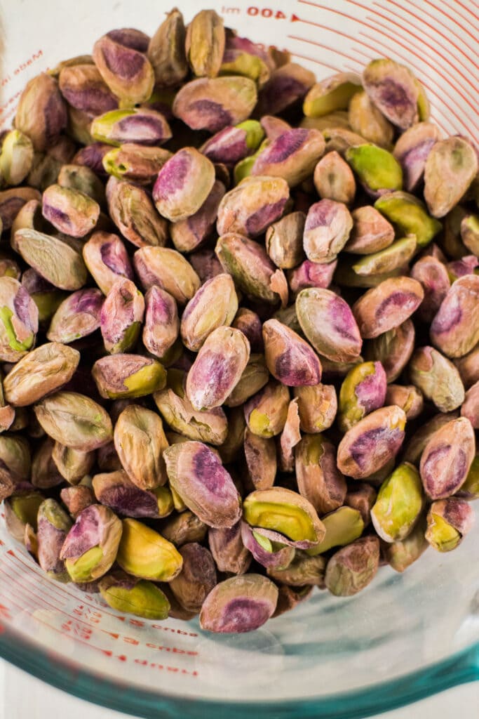 raw pistachios in measuring cup.