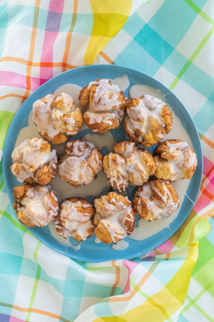 cinnamon rolls on colorful tablecloth on blue plate.