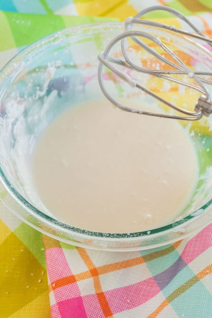 vanilla icing in glass bowl.