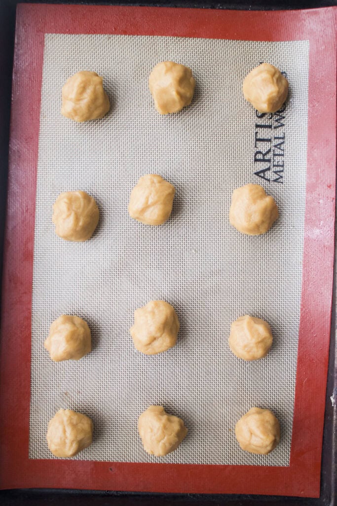 peanut butter cookie balls on baking sheet.