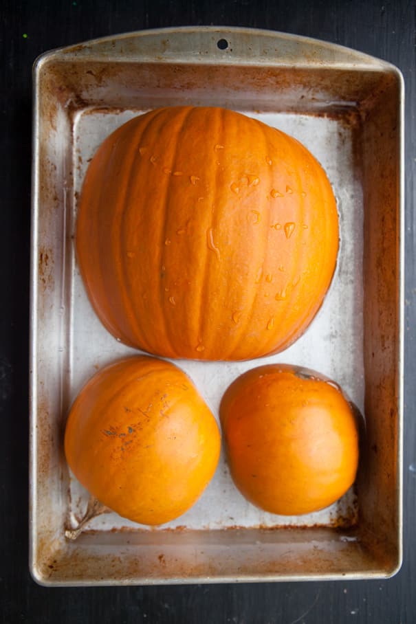 pumpkins cut in half in baking dish
